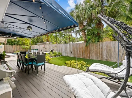 a view of outdoor dining space with a table and chairs
