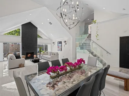 a view of a dining room with furniture a rug and wooden floor