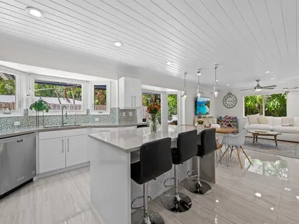 a kitchen with lots of counter top space and painting on the wall