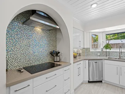 a bathroom with a granite countertop sink a toilet and vanity