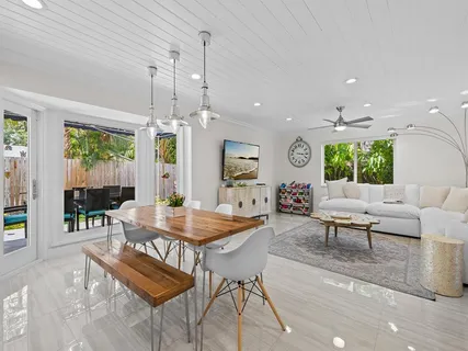 a living room with furniture a chandelier and a table