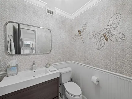 a bathroom with a toilet sink and mirror
