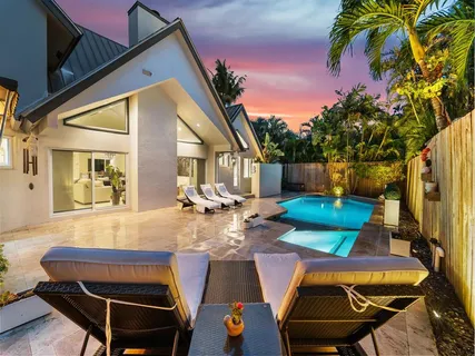 a view of a patio with table and chairs with wooden floor and fence