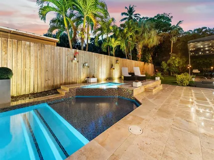 a swimming pool with outdoor seating and yard