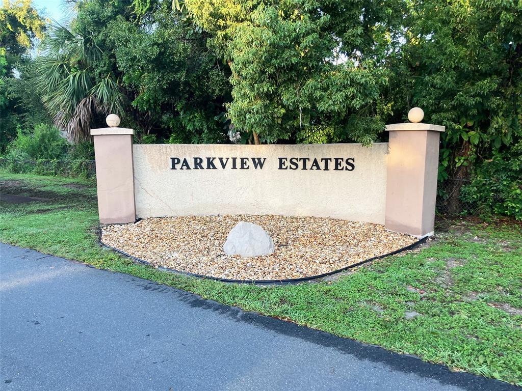 1221 12th Court Southwest Largo, FL 33770 - Photo 2 of 13 a view of a park with a bench and trees