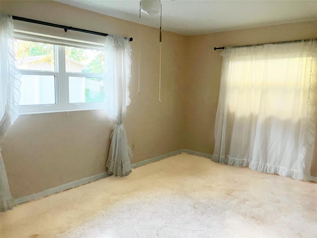 1221 12th Court Southwest Largo, FL 33770 - Photo 6 of 13 a view of empty room with floor to ceiling window and shower