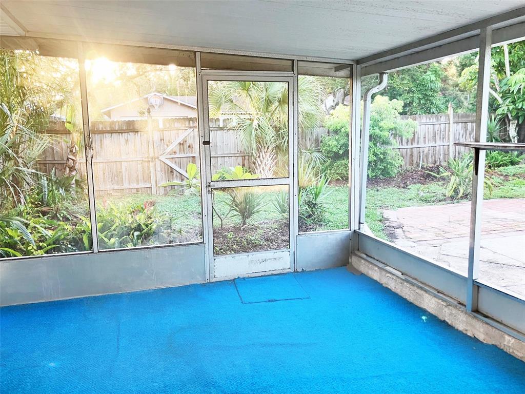 1221 12th Court Southwest Largo, FL 33770 - Photo 9 of 13 a view of an empty room with wooden floor and a window
