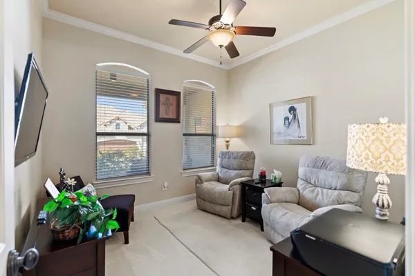 a living room with furniture flower pot and a window