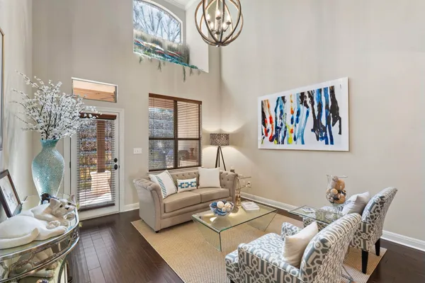 a living room with furniture a couch and a chandelier
