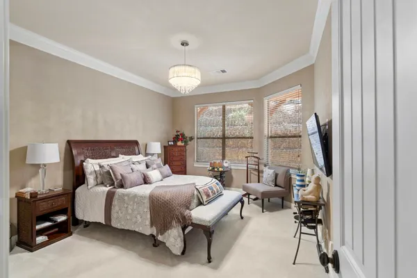 a bedroom with furniture and a large window