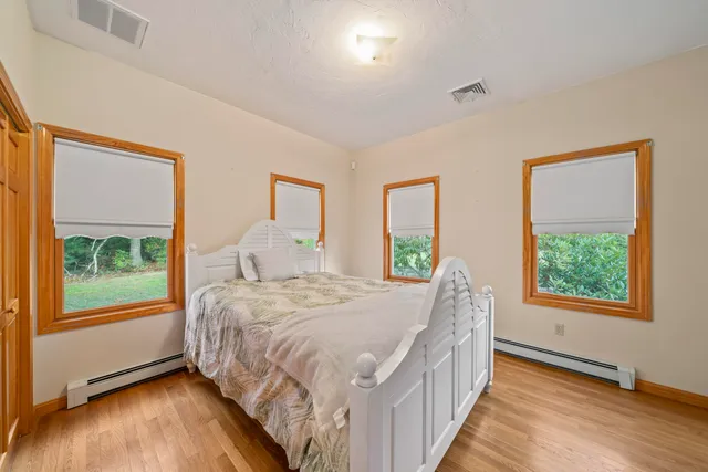 a bed sitting in a bedroom next to a window