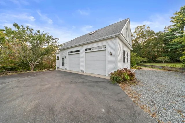 a view of a house with a yard and garage
