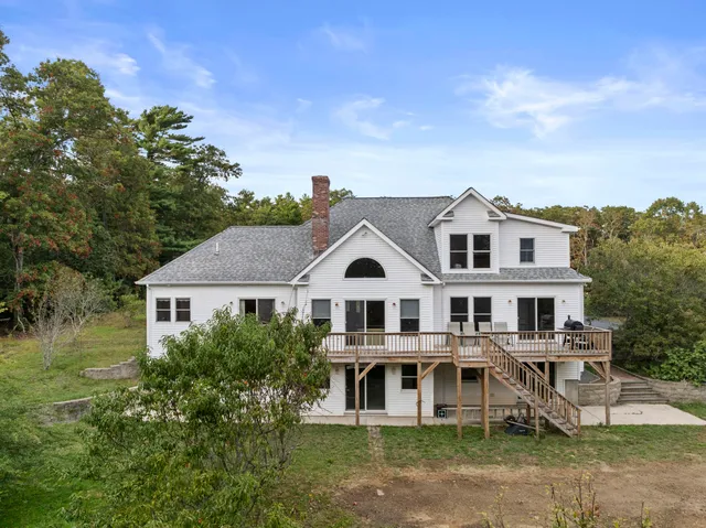 a front view of a house with a garden and plants