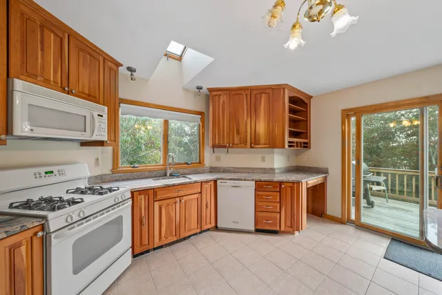 a kitchen with stainless steel appliances granite countertop a stove a sink dishwasher and a refrigerator