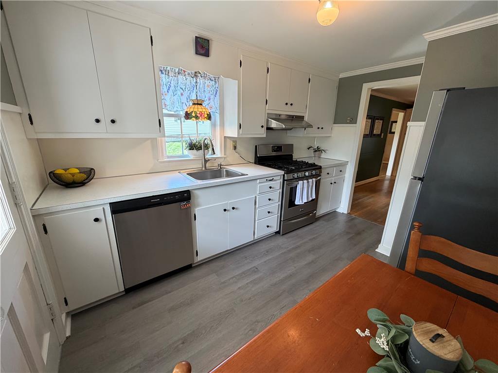 974 Juniper Road Hellertown, PA 18055 - Photo 3 of 45 A well-appointed kitchen features ample white cabinetry, stainless steel appliances, and newer LVIP flooring.