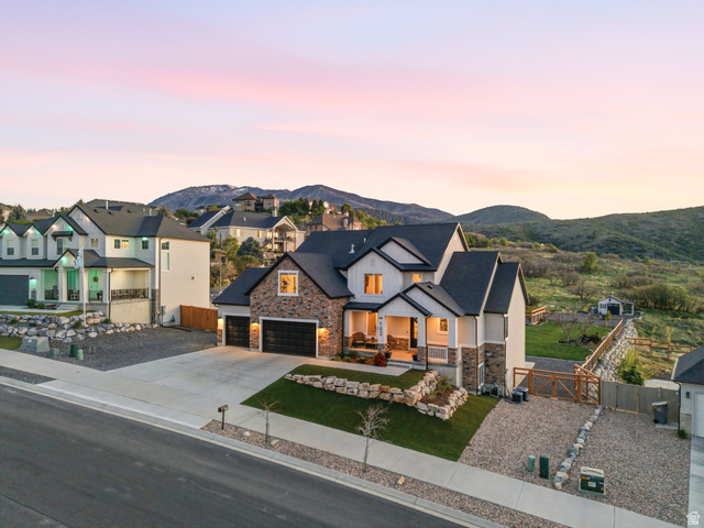 102 Elk Ridge Drive Elk Ridge, UT 84651 - Photo 2 of 61 Modern farmhouse style home featuring a gate, covered porch, driveway, and stone siding