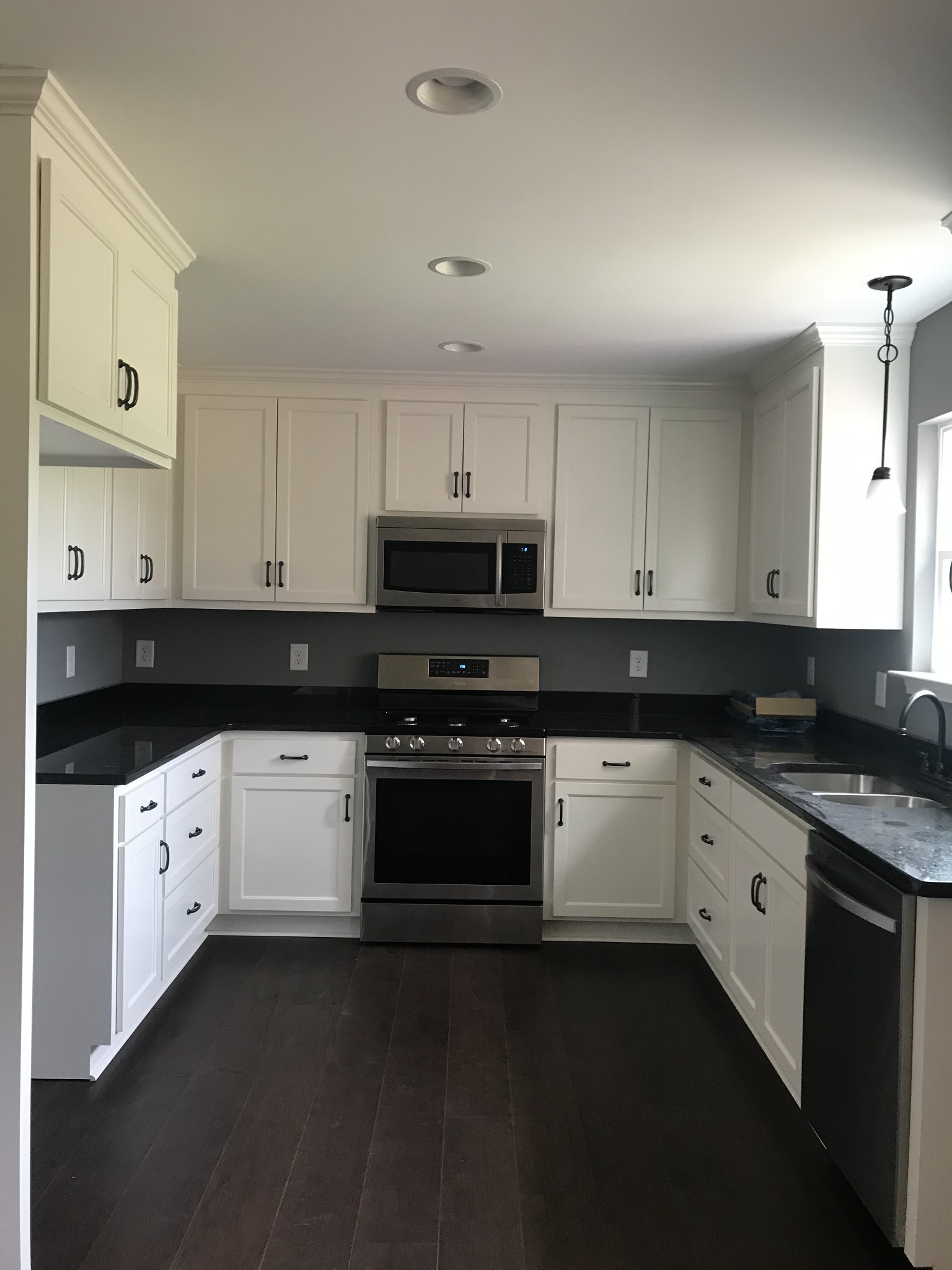 461 Pruett Road Dickson, TN 37055 - Photo 7 of 20 a kitchen with granite countertop white cabinets and black appliances