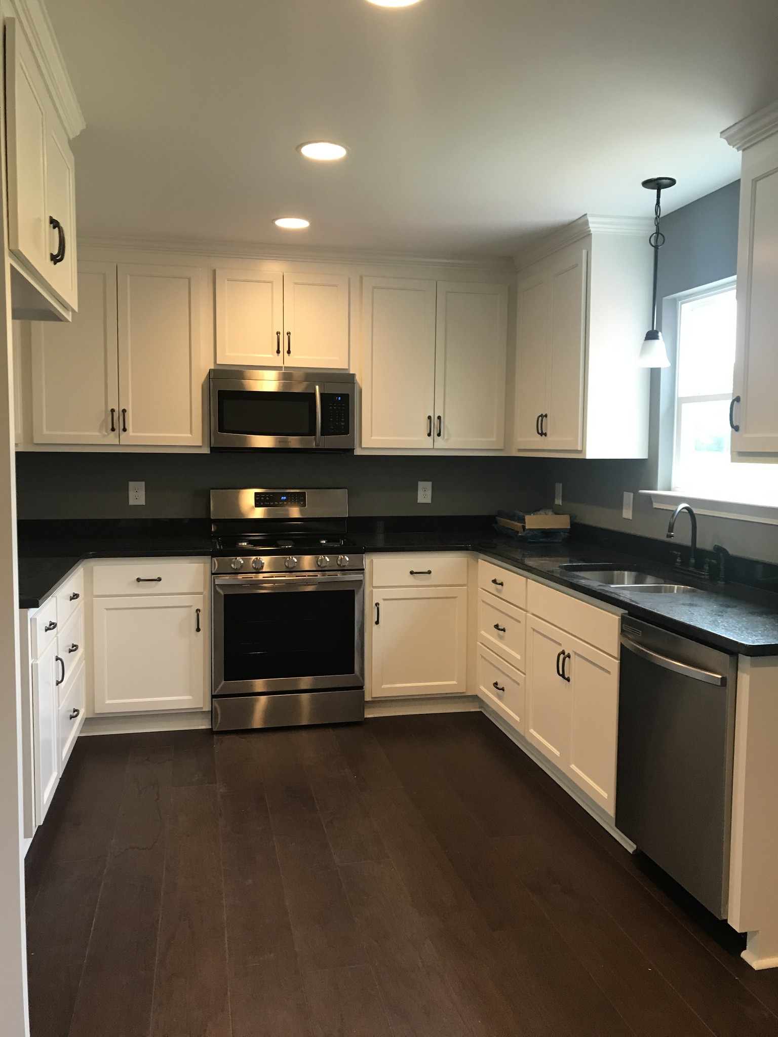 461 Pruett Road Dickson, TN 37055 - Photo 8 of 20 a kitchen with granite countertop white cabinets and black stainless steel appliances