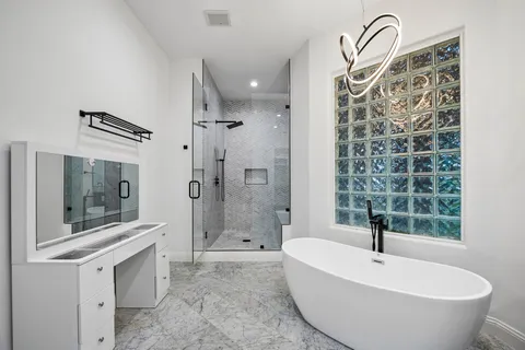 a bathroom with a bathtub and a shower