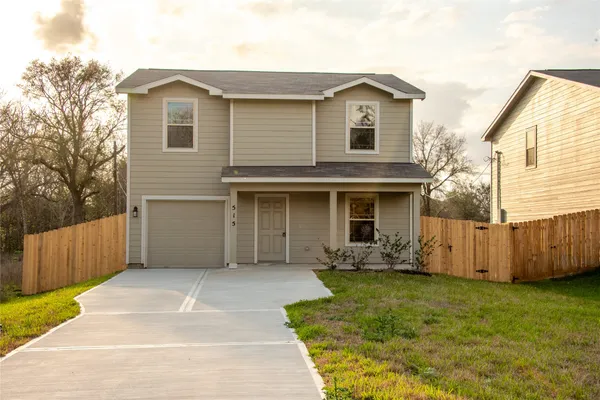 a view of a house with wooden fence