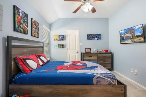 a bedroom with a bed and a painting on the wall