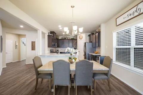 a view of a dining room with furniture and window
