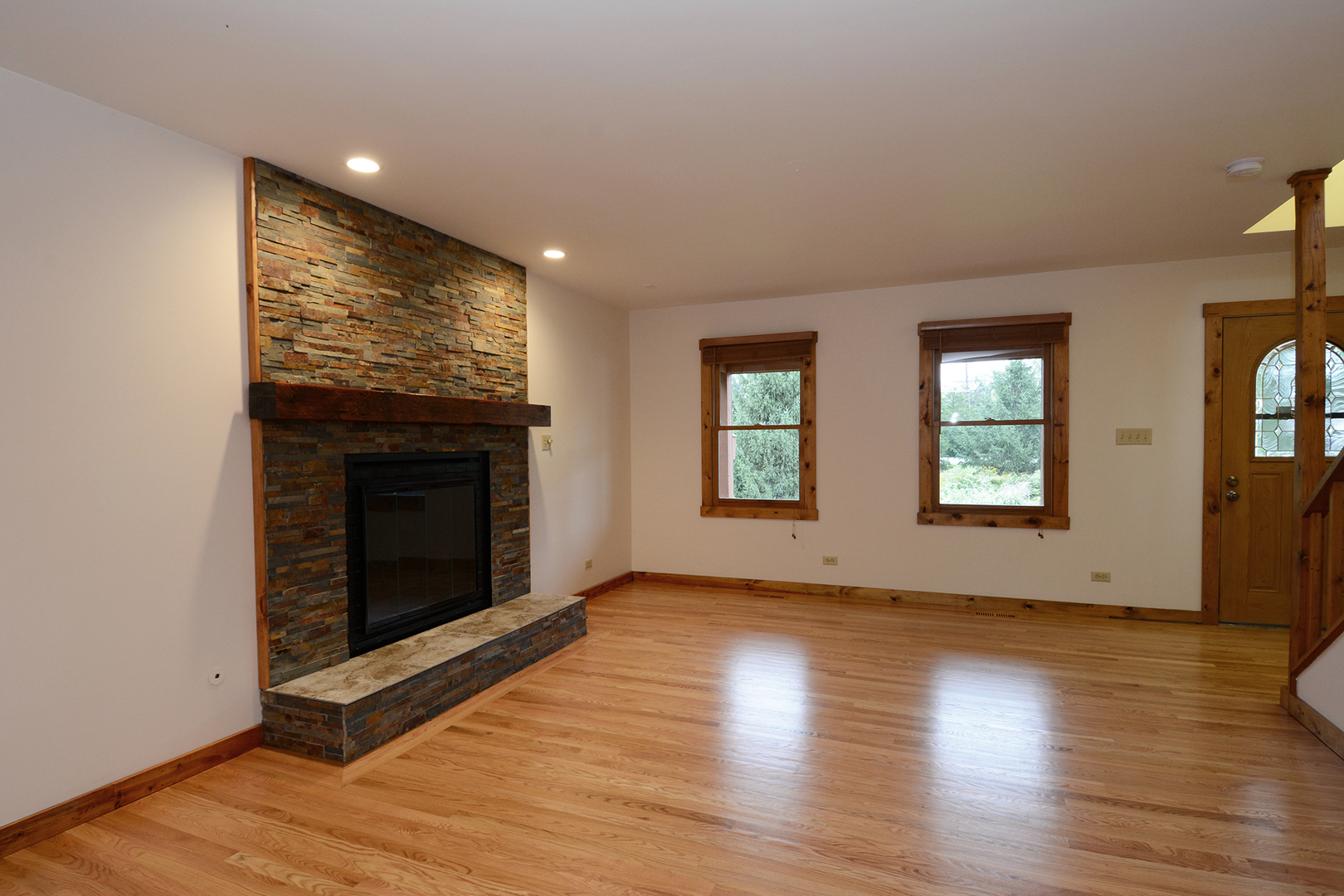 44W290 Plank Road Hampshire, IL 60140 - Photo 5 of 31 an empty room with wooden floor fireplace and windows