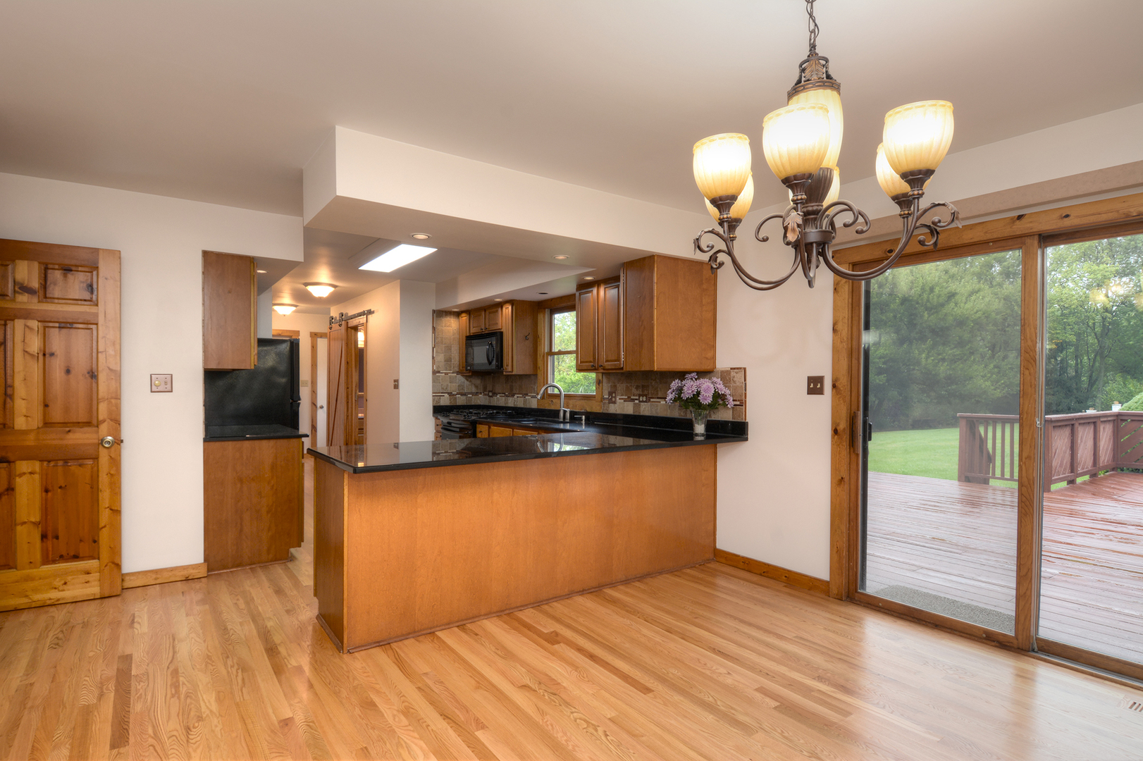 44W290 Plank Road Hampshire, IL 60140 - Photo 7 of 31 a view of a kitchen with a sink and cabinet with wooden floor