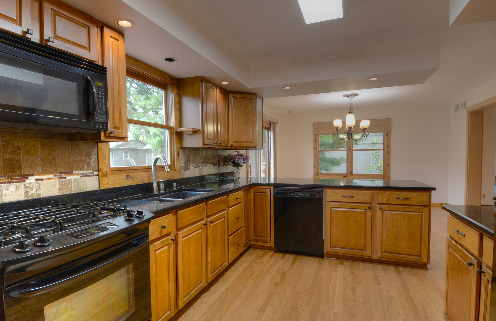 44W290 Plank Road Hampshire, IL 60140 - Photo 8 of 31 a kitchen with stainless steel appliances granite countertop a stove a sink and a microwave