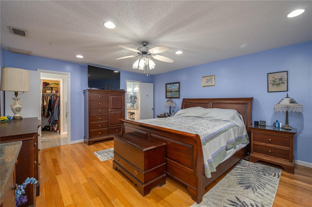 305 Hernando Road Winter Haven, FL 33884 - Photo 13 of 32 a bed room with a bed and a chandelier