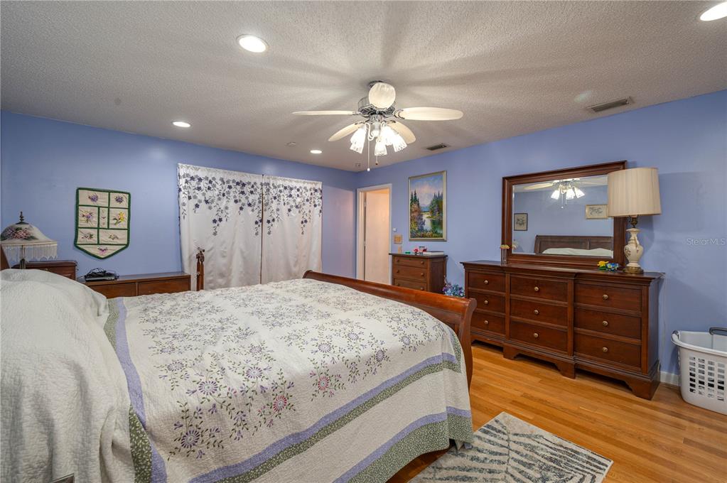 305 Hernando Road Winter Haven, FL 33884 - Photo 14 of 32 a bedroom with a bed and a chandelier