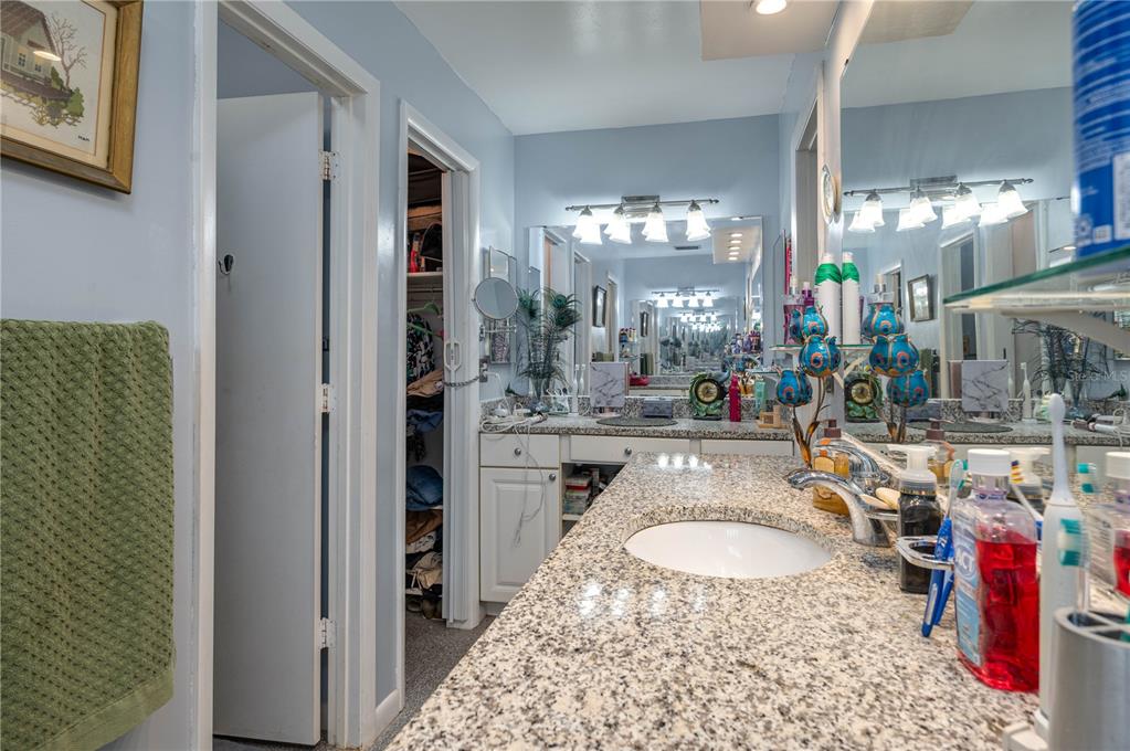 305 Hernando Road Winter Haven, FL 33884 - Photo 17 of 32 a bathroom with a granite countertop sink a mirror and shower