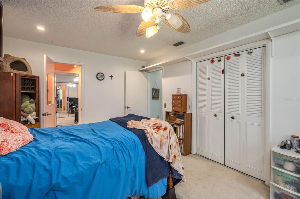 305 Hernando Road Winter Haven, FL 33884 - Photo 19 of 32 a bedroom with a bed and a chandelier