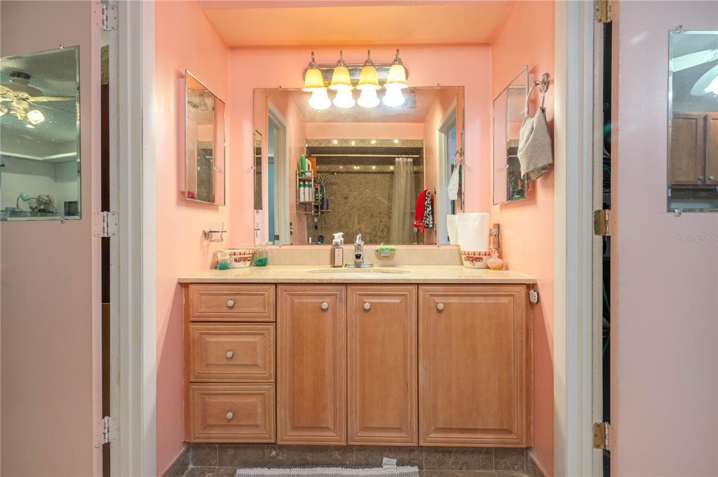 305 Hernando Road Winter Haven, FL 33884 - Photo 20 of 32 a bathroom with a double vanity sink and a mirror