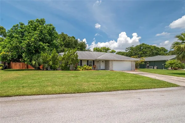 a front view of a house with a yard and a garage