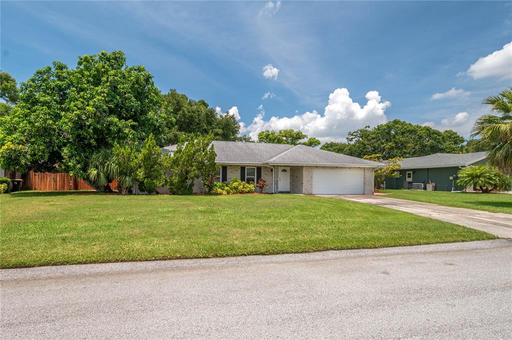 305 Hernando Road Winter Haven, FL 33884 - Photo 2 of 32 a front view of a house with a yard and a garage
