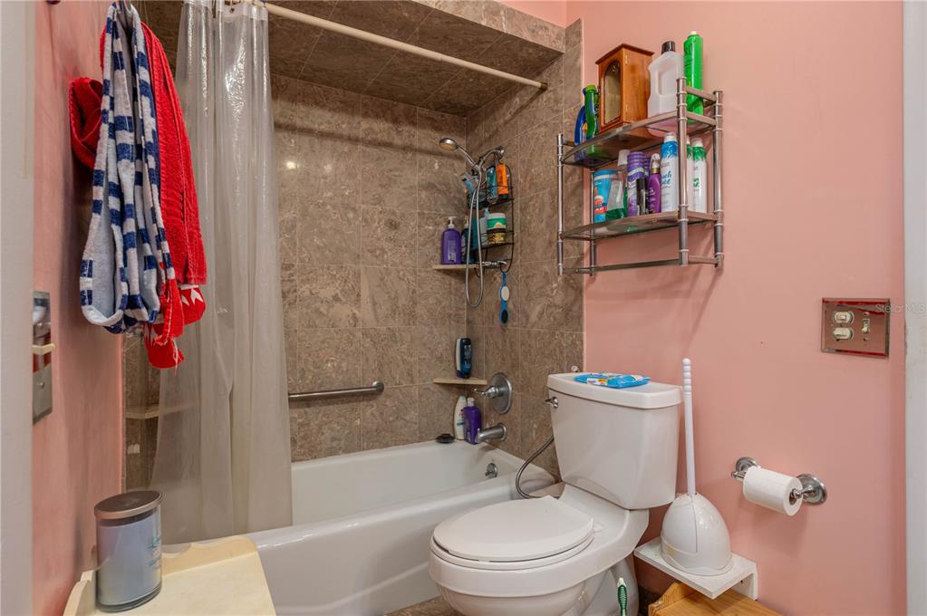 305 Hernando Road Winter Haven, FL 33884 - Photo 21 of 32 a white toilet sitting next to a bathroom sink and tub