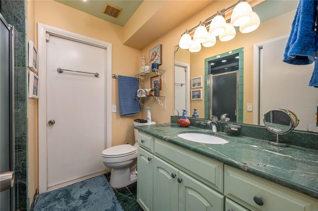 305 Hernando Road Winter Haven, FL 33884 - Photo 23 of 32 a bathroom with a granite countertop sink toilet and shower