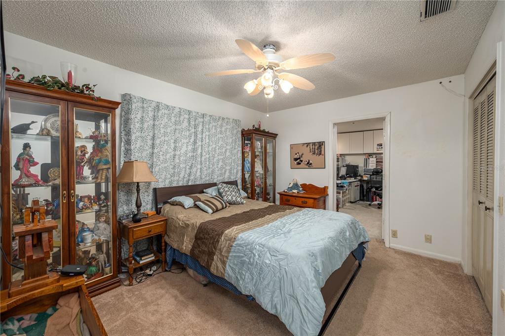 305 Hernando Road Winter Haven, FL 33884 - Photo 26 of 32 a bedroom with a bed and a chandelier