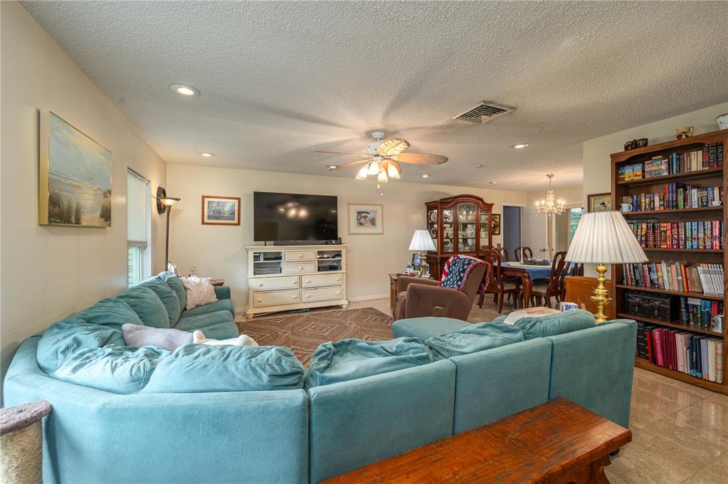 305 Hernando Road Winter Haven, FL 33884 - Photo 5 of 32 a living room with furniture and a flat screen tv
