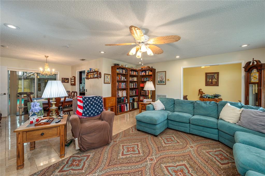 305 Hernando Road Winter Haven, FL 33884 - Photo 6 of 32 a living room with furniture kitchen and a chandelier