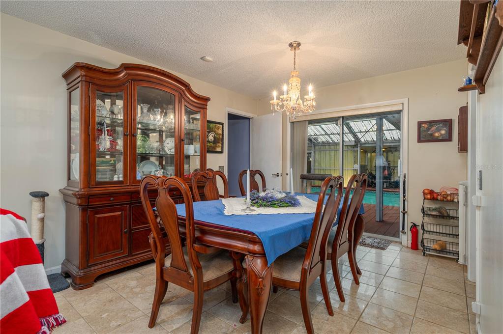305 Hernando Road Winter Haven, FL 33884 - Photo 7 of 32 a view of a dining room with furniture and chandelier