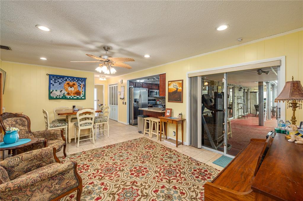 305 Hernando Road Winter Haven, FL 33884 - Photo 9 of 32 a living room with furniture a flat screen tv and a table