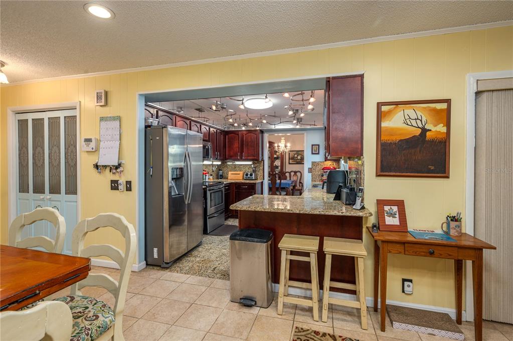 305 Hernando Road Winter Haven, FL 33884 - Photo 10 of 32 a view of a kitchen area with furniture and chandelier