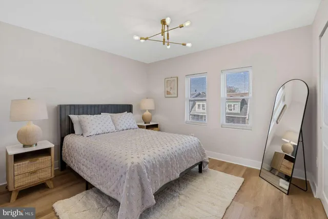 a view of a hallway with potted plants by a wooden floor