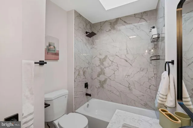 a view of a room with wooden floor and chandelier fan