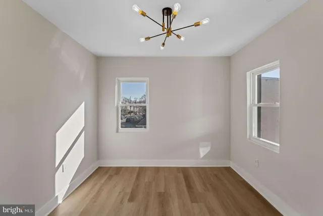 a view of room with hardwood floor and white cabinet