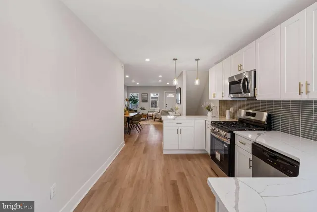 a kitchen with a sink a stove top oven and white kitchen