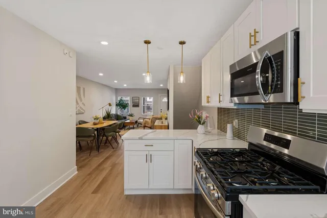 a kitchen with a stove a sink and a microwave
