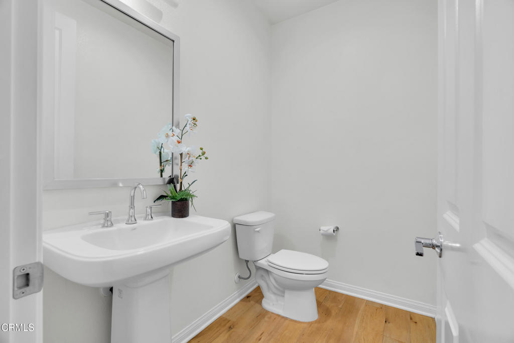 900 North Primrose Lane, Unit A Azusa, CA 91702 - Photo 17 of 55 a bathroom with a sink toilet and a mirror